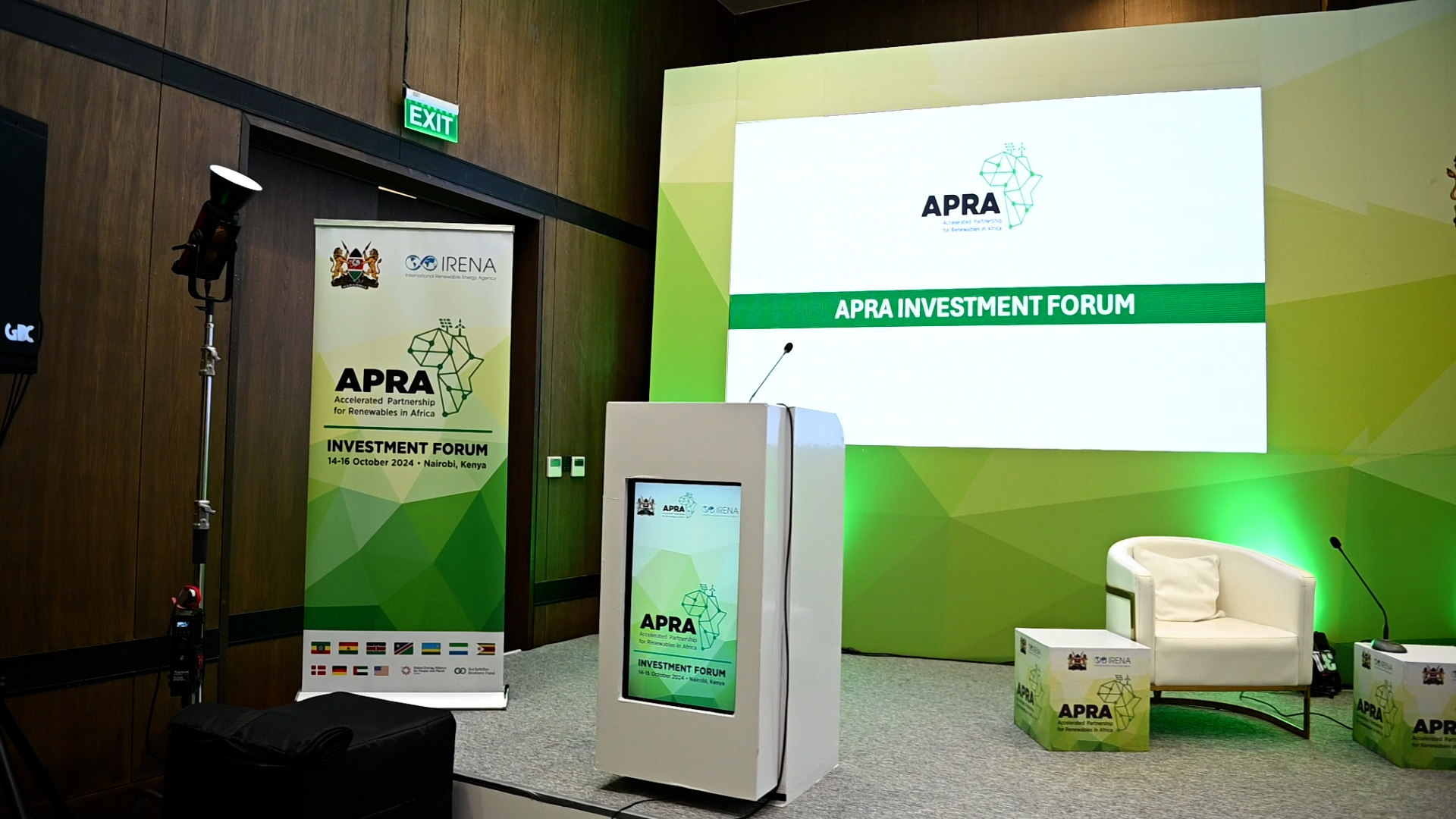 APRA Investment Forum stage with branded screen, podium and seating