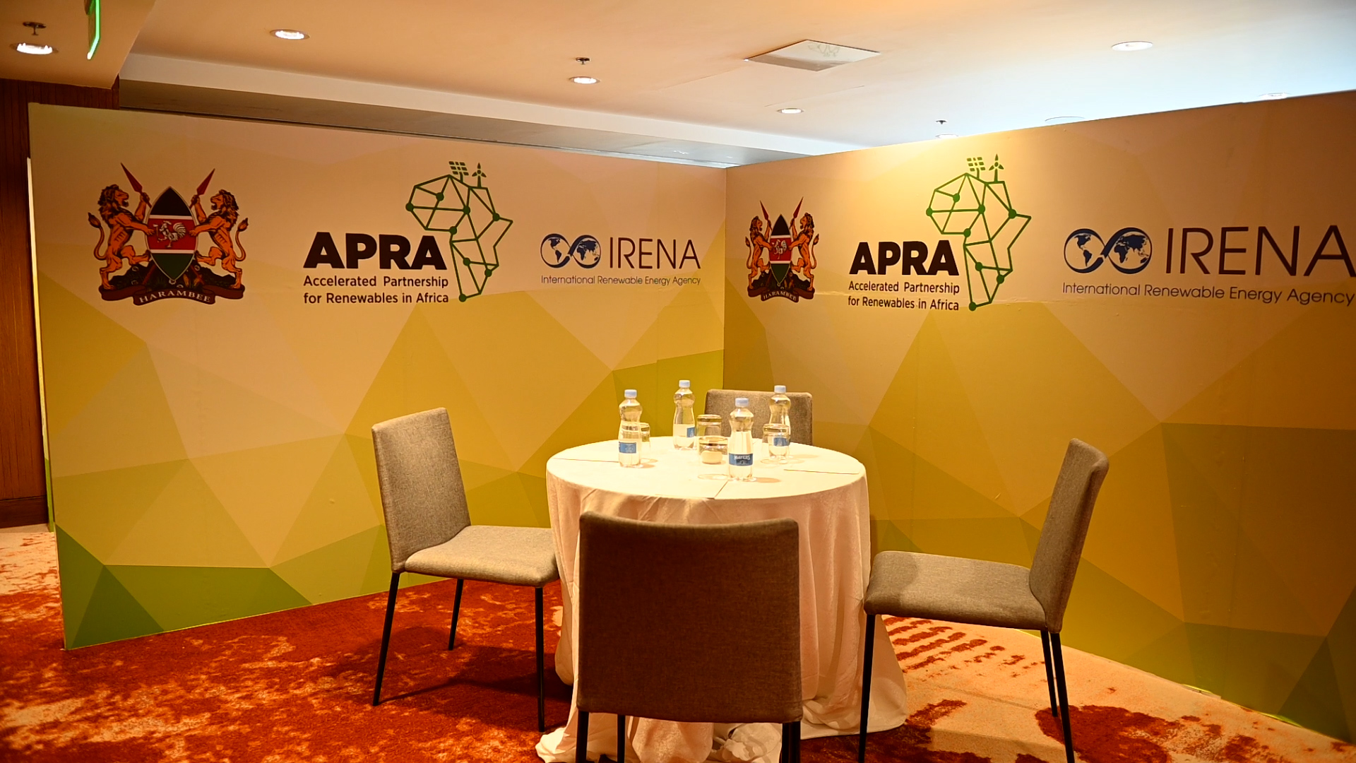 APRA and IRENA branded meeting area with table