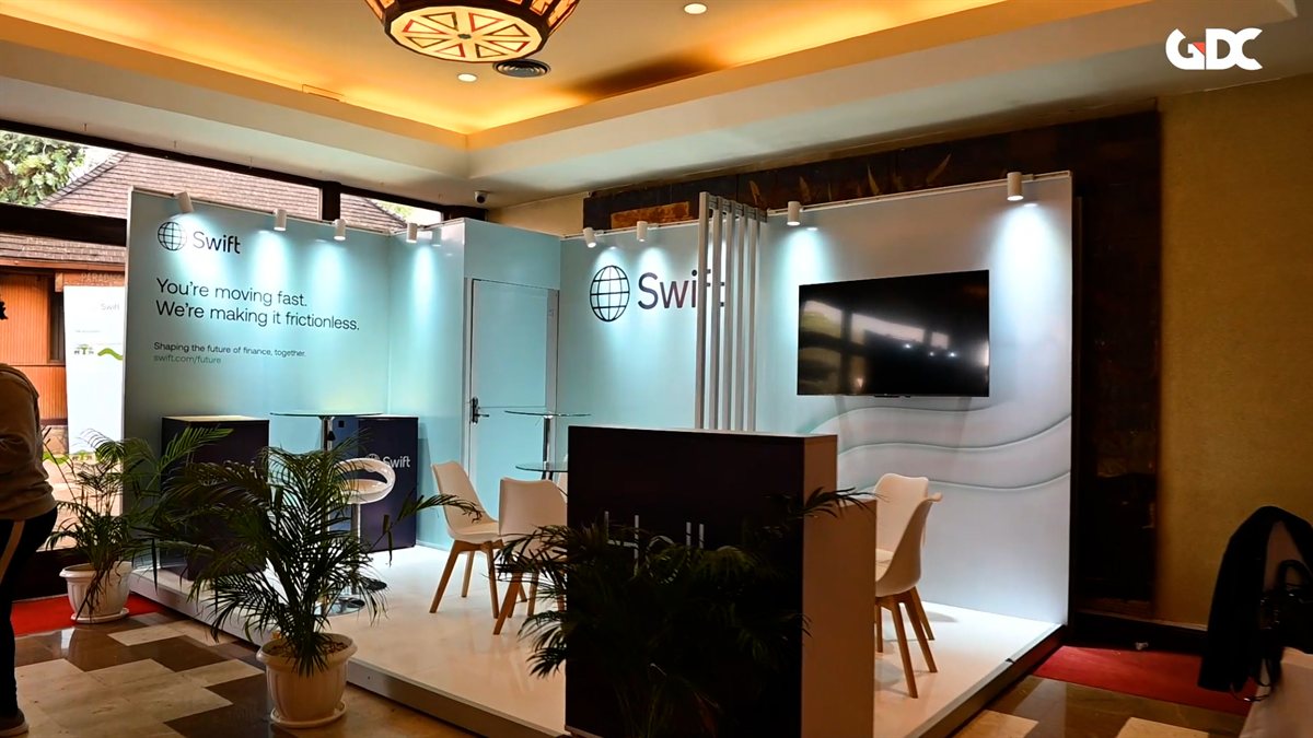 A branded Swift exhibition stand with screens and seating at Swift Connect Africa
