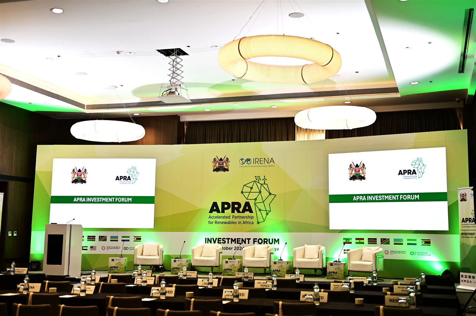 APRA Investment Forum stage with branded screens and seating